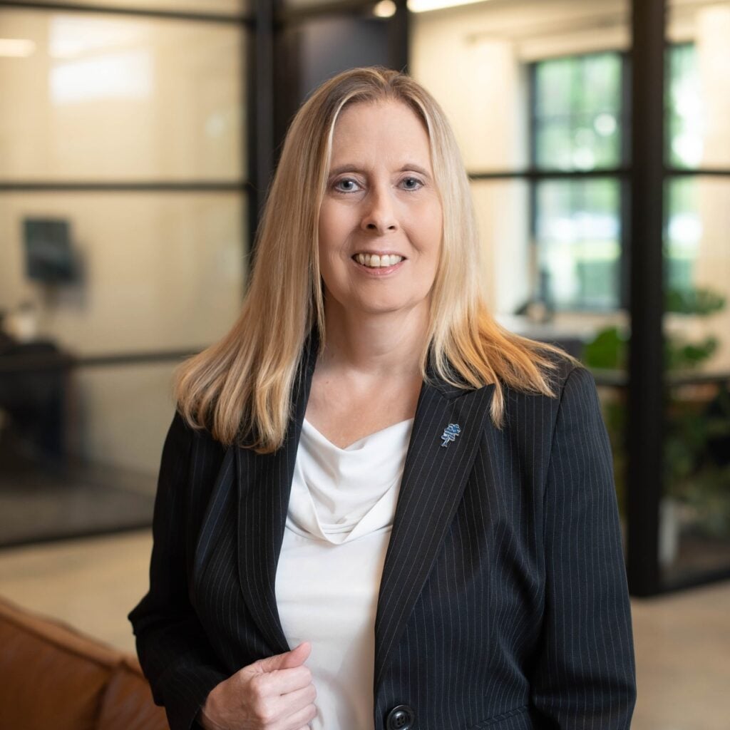 Smiling professional woman in office setting.