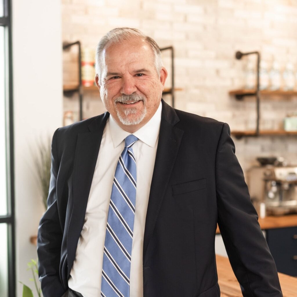 Smiling man in suit in bright office