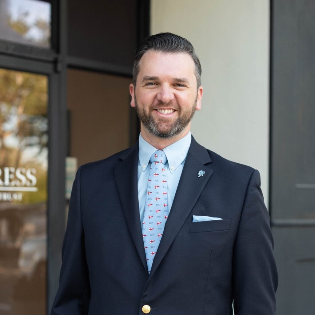 Smiling man in suit with patterned tie