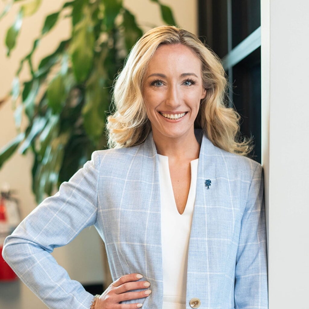 Smiling professional woman in a light blue blazer