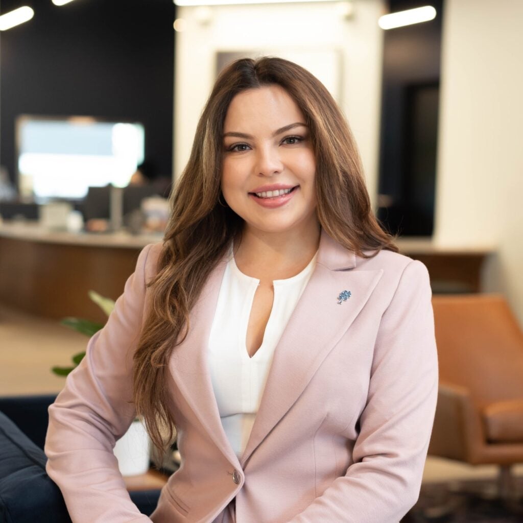 Professional woman smiling in office setting.