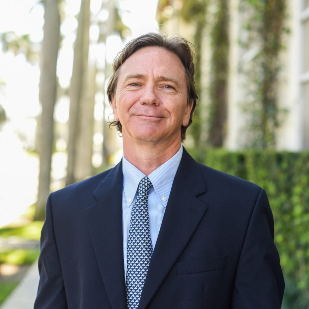 Man in suit smiling outdoors