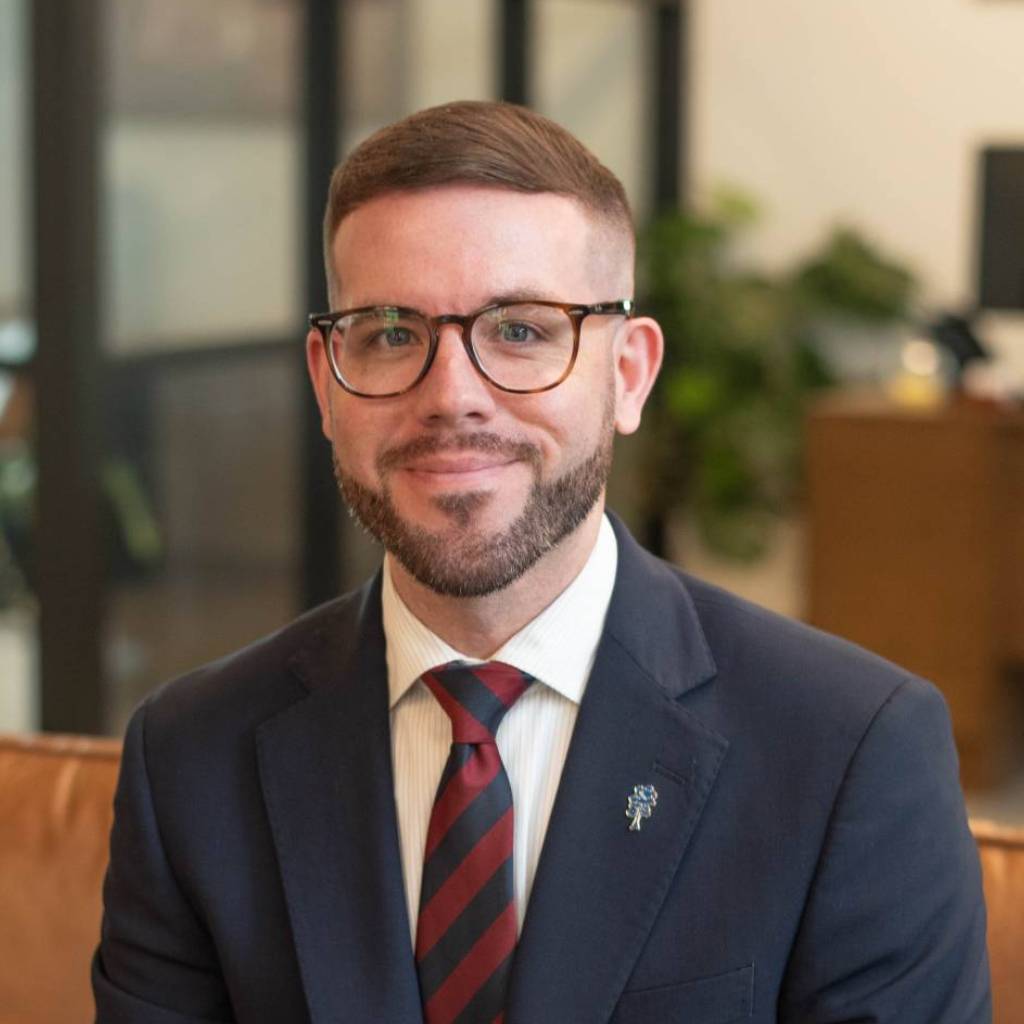 Smiling man in suit and tie indoors